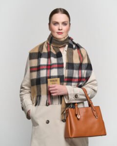A couple sharing a cosy winter moment, each wearing an Edinburgh Lambswool scarf