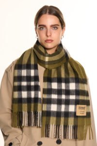 Artisan hands weaving Scottish cashmere on a traditional loom, showcasing premium material.