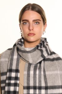 Model styling a pure cashmere scarf with an elegant evening outfit
