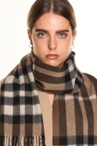 A cream-colored cashmere scarf in a stylish premium box.
