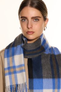 A navy plaid cashmere scarf in a luxury handcrafted gift box.