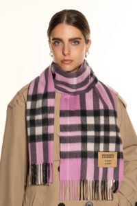 A close-up of an iconic red tartan cashmere scarf, symbolizing prosperity and Scottish tradition.