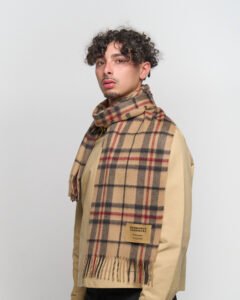 Classic tartan and solid scarves displayed to show heritage craftsmanship